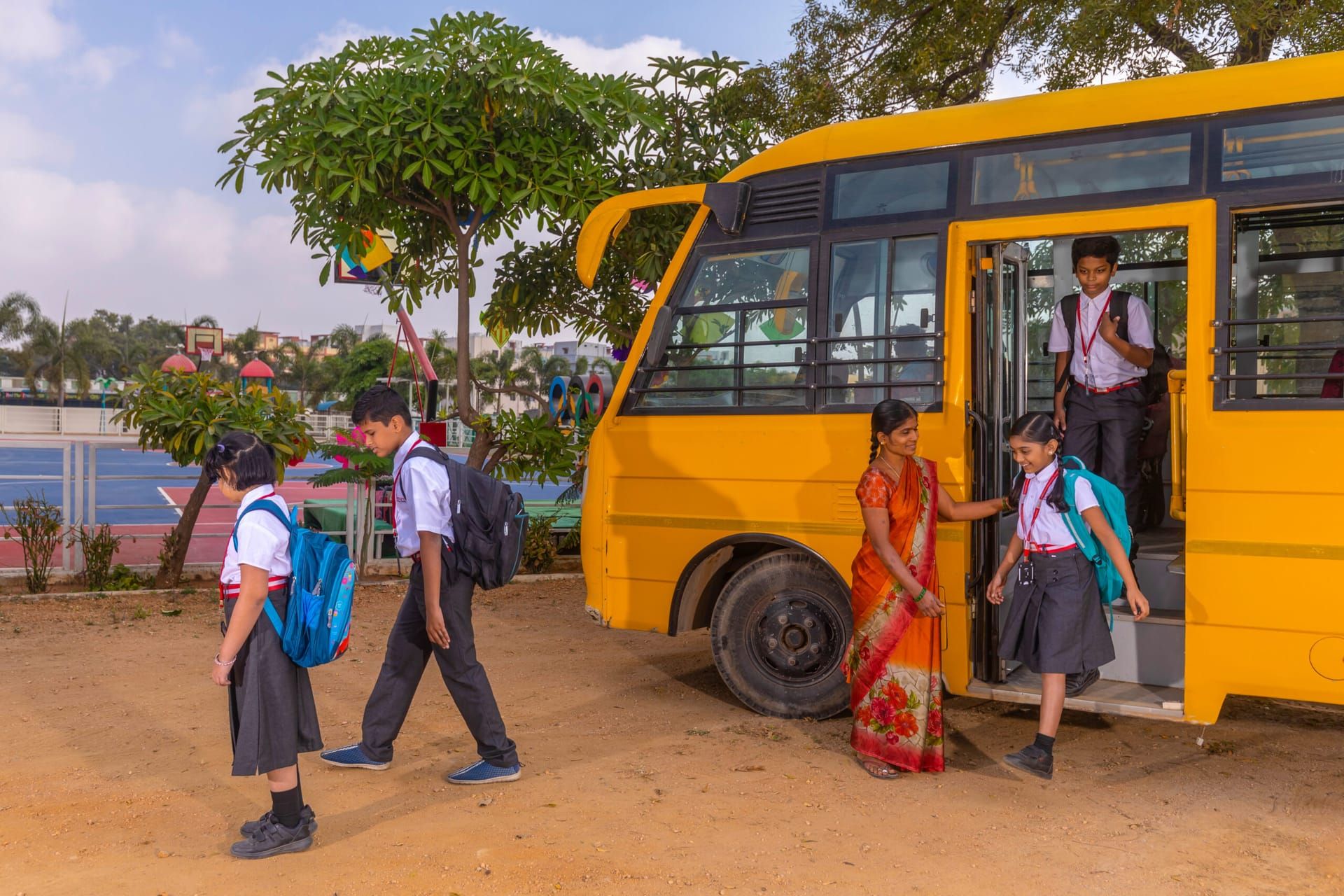 Students stepping off an Akshara school bus