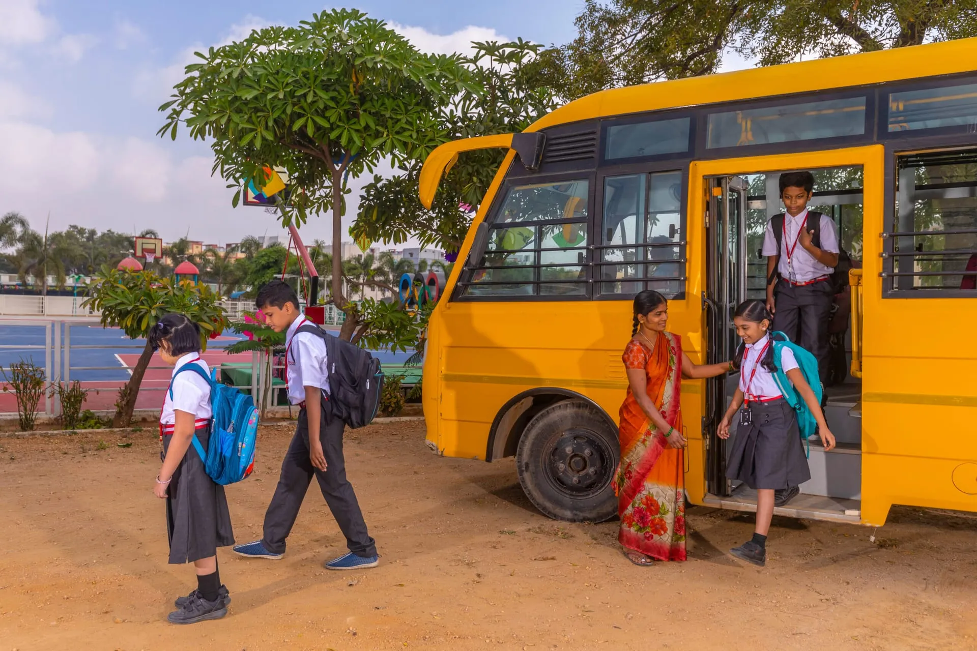 Students stepping off an Akshara school bus