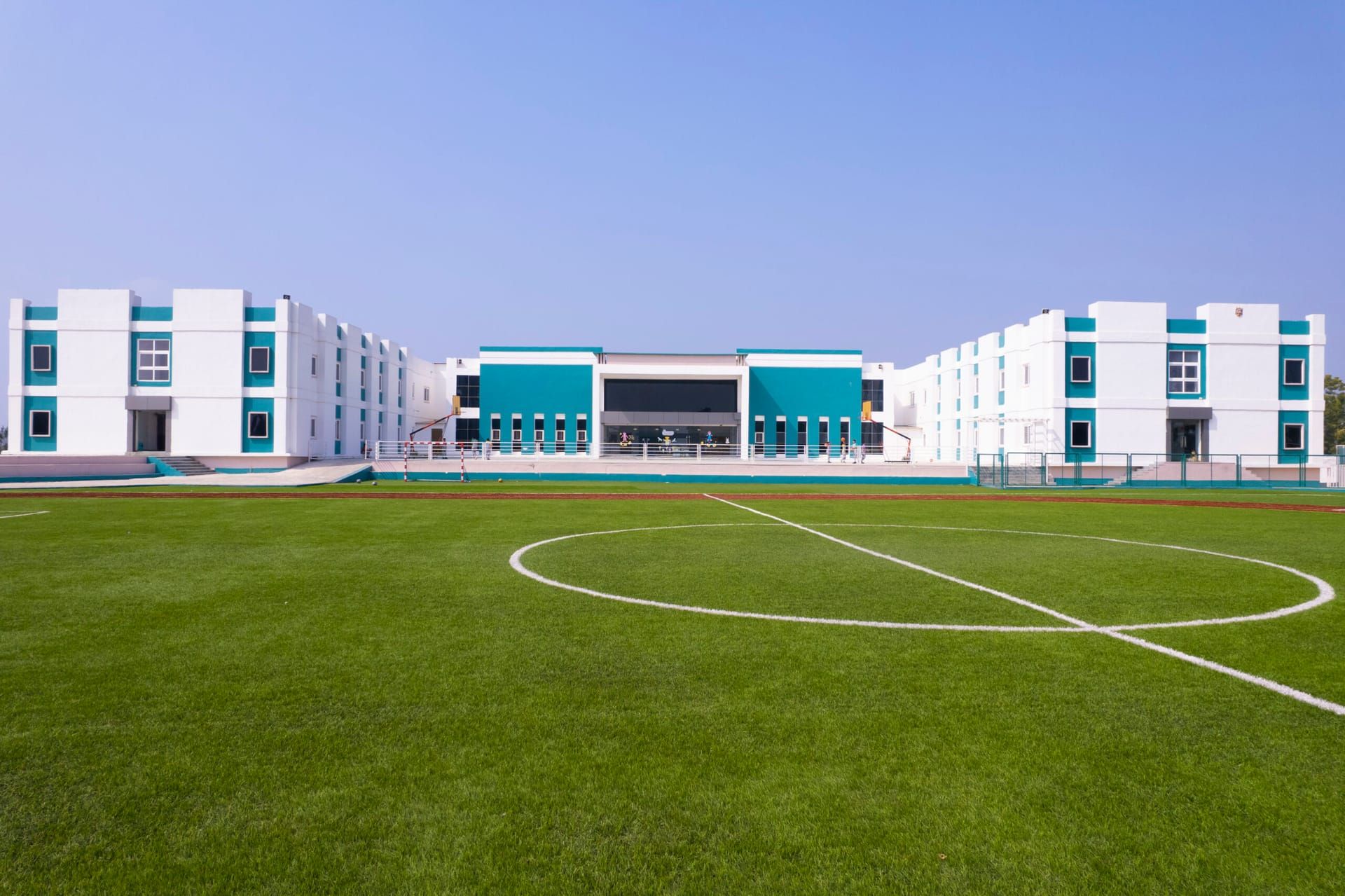 Akshara campus football field in front of the school blocks