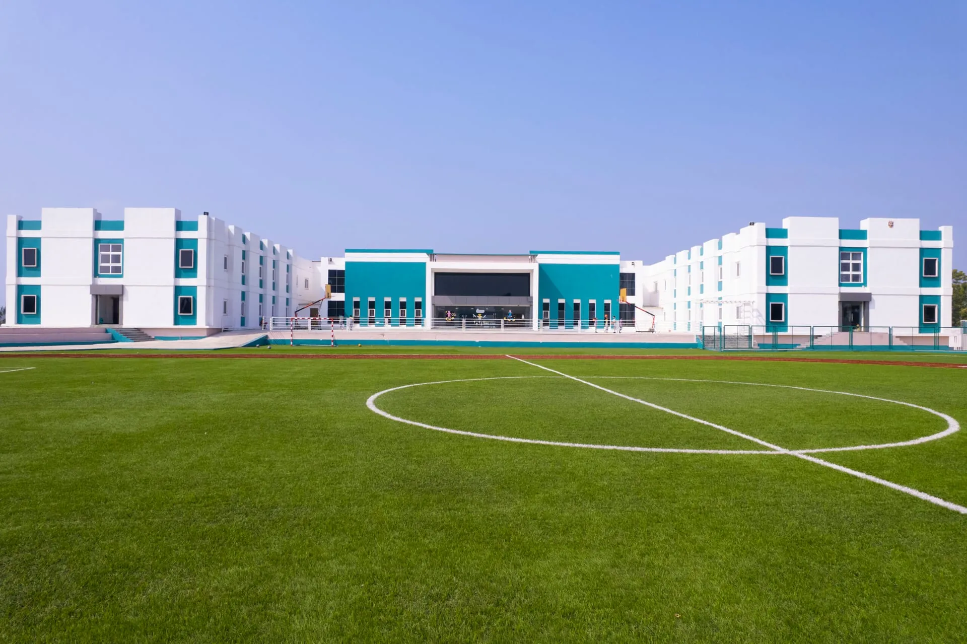 Akshara campus football field in front of the school blocks