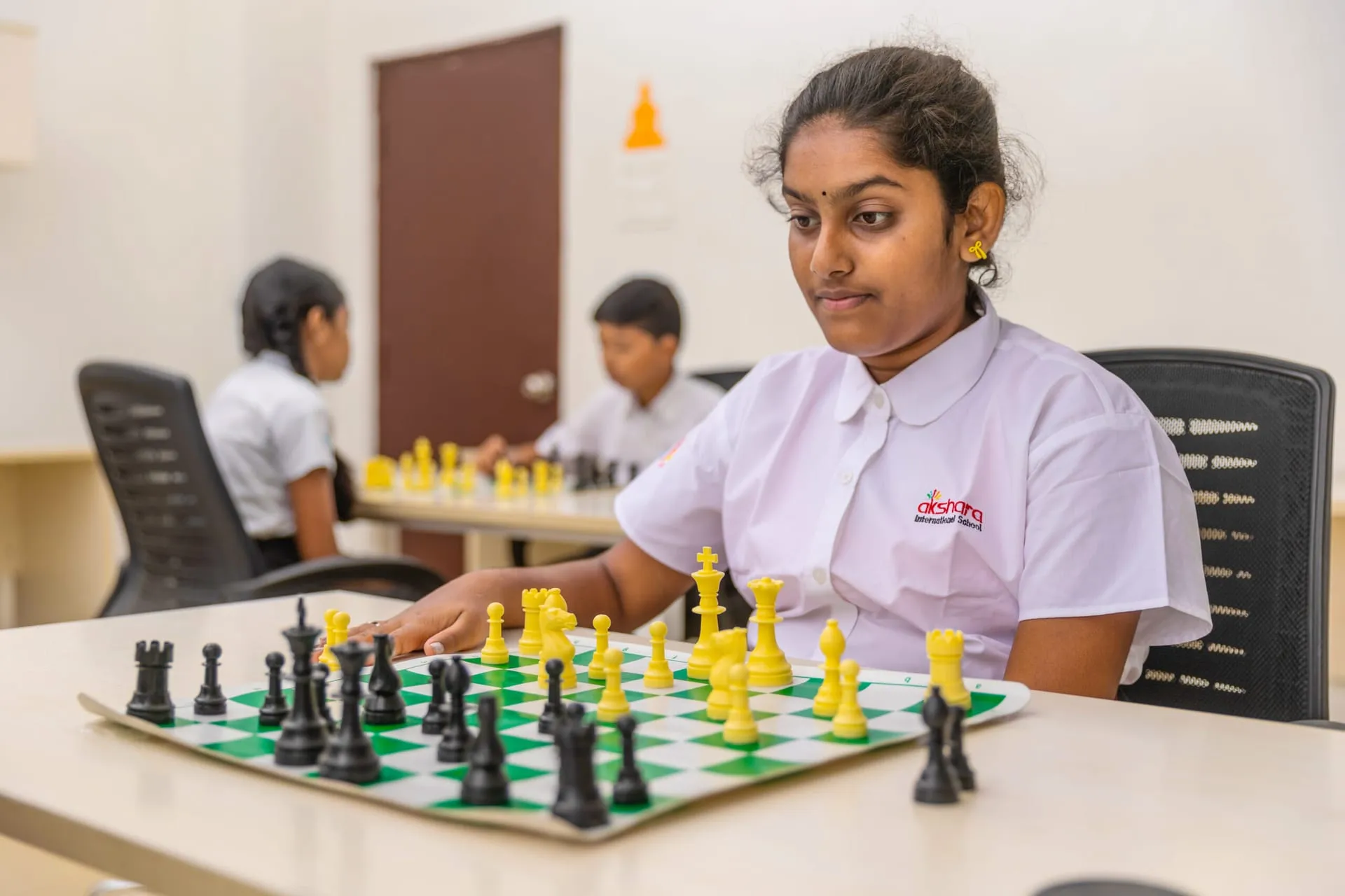 Student concentrating on a game of chess