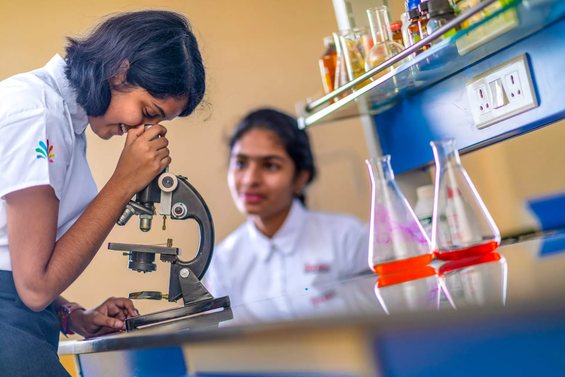 Student looking through a microscope in the biology lab