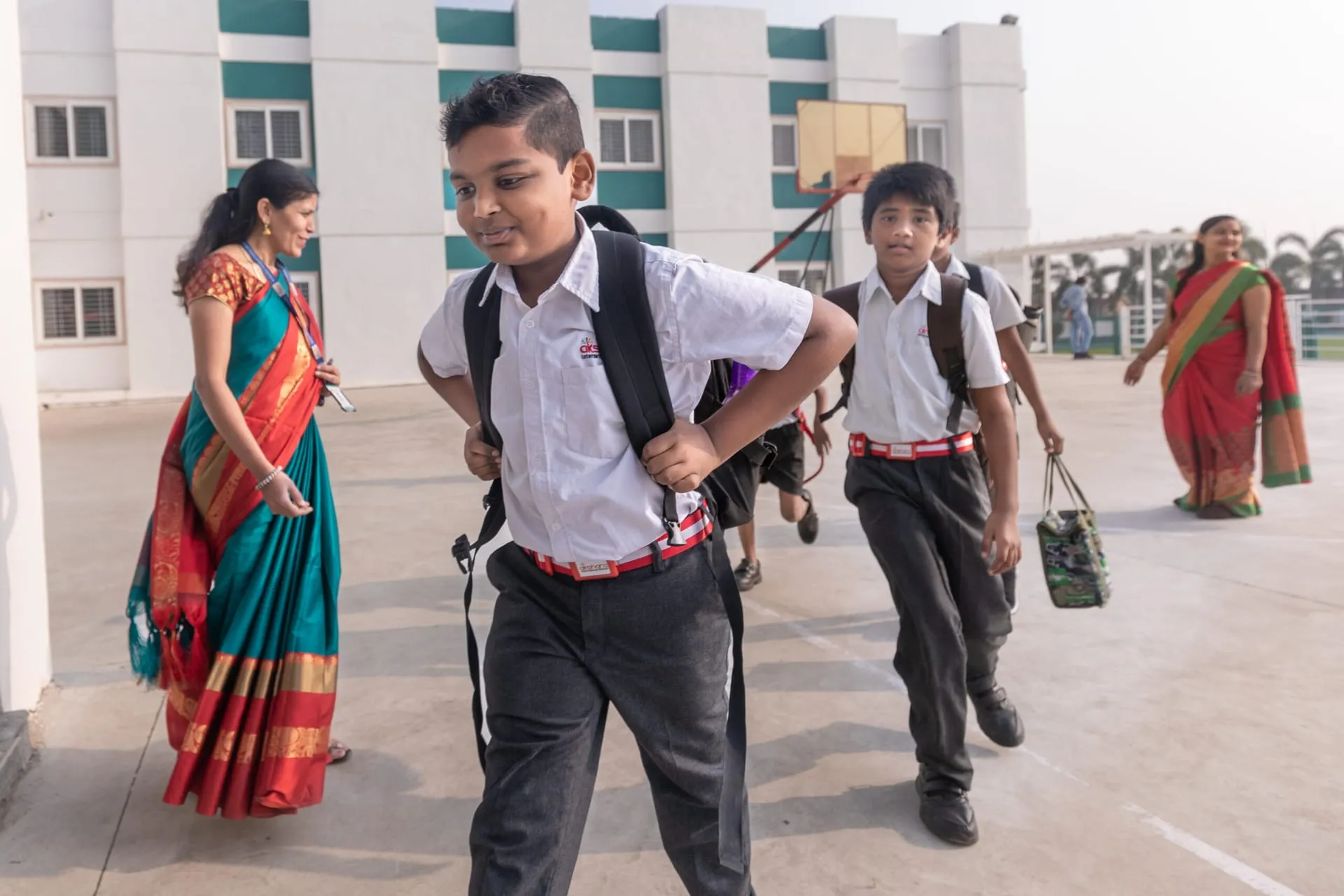 Students and teachers arriving at an Akshara campus in the morning