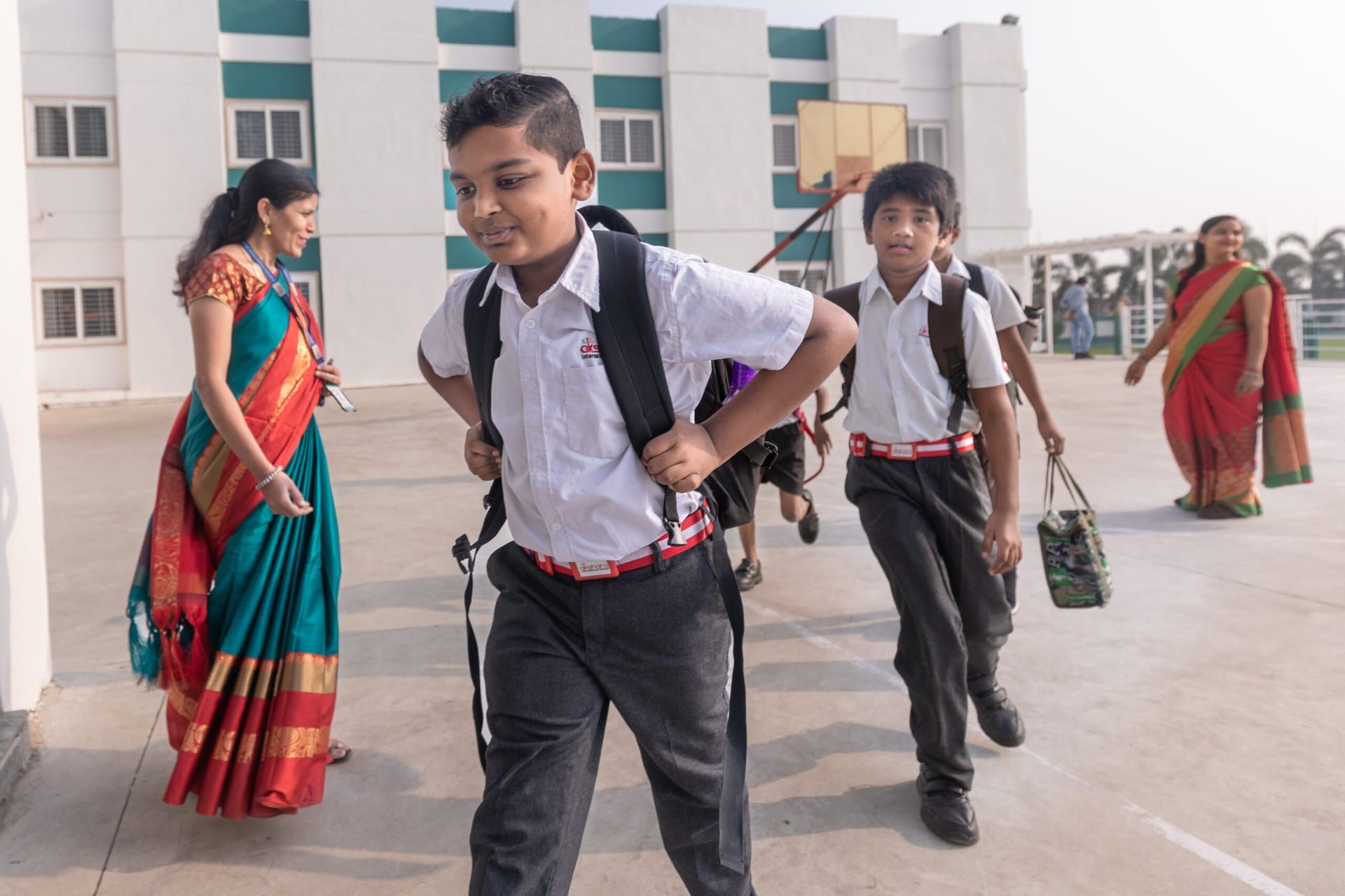 Students and teachers arriving at an Akshara campus in the morning