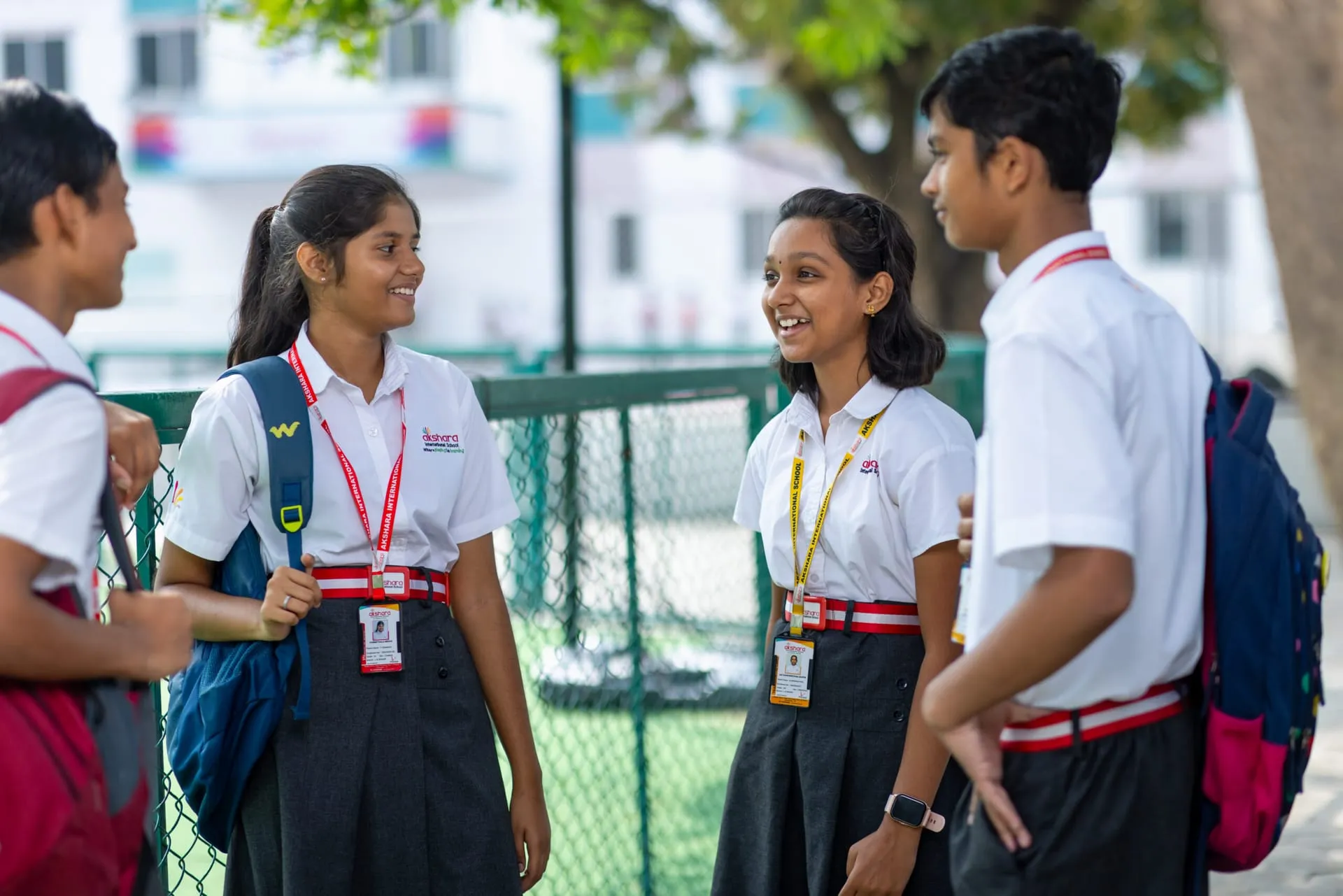Smiling Akshara secondary students chatting on campus