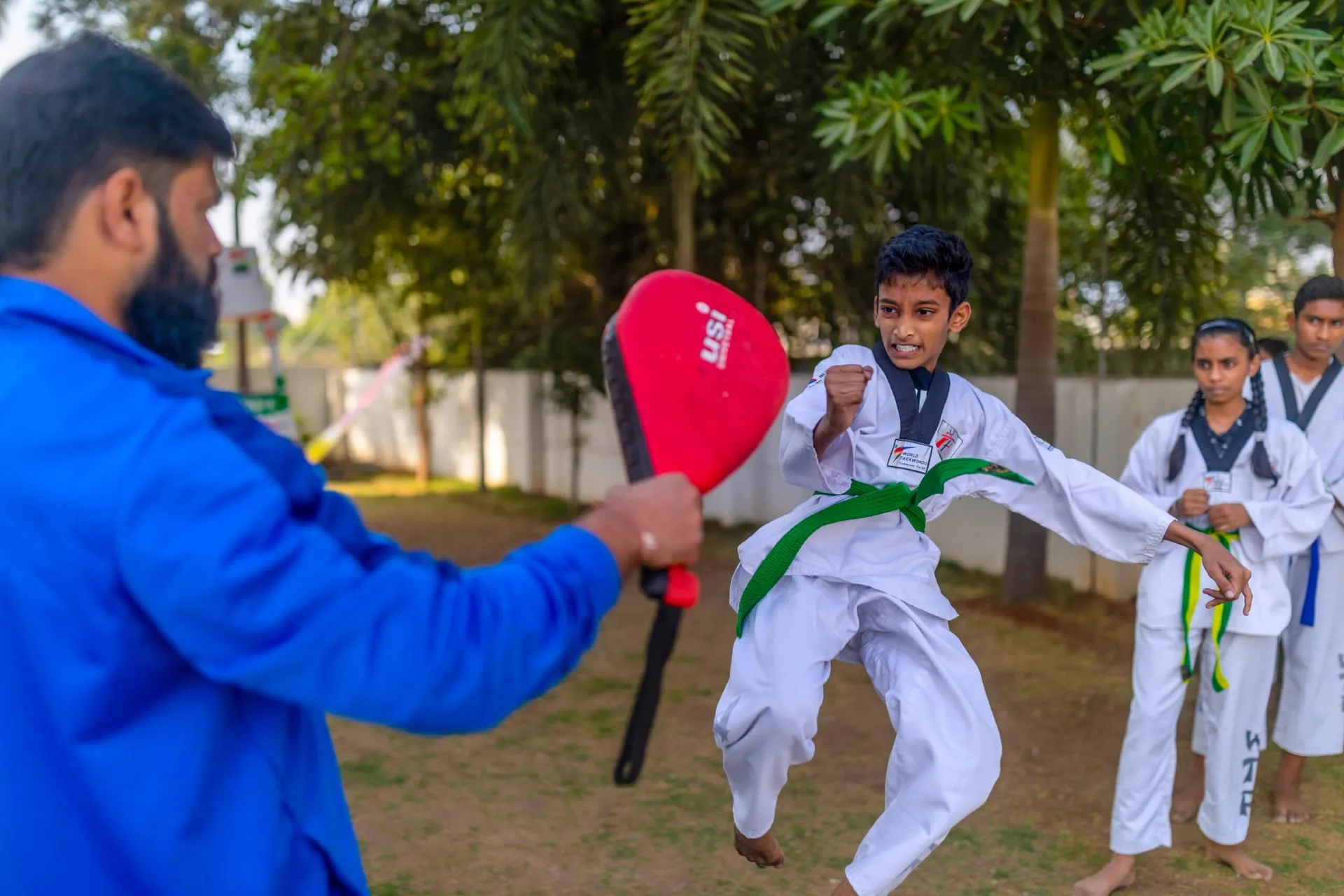 Student practising taekwondo with a coach